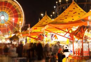 County Fair midway with Ferris Wheel and merchants.